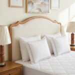 Elegant upholstered solid wood platform bed with curved headboard and footboard in natural wood finish for modern bedroom décor.