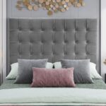 Luxury grey velvet upholstered platform bed with a tall square tufted headboard in a contemporary modern bedroom setting.
