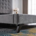 Luxury grey velvet upholstered platform bed with a tall square tufted headboard in a contemporary modern bedroom setting.