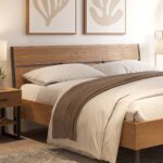 Modern rustic wooden platform bed with a natural oak finish, black metal frame, and minimalist industrial design in a contemporary bedroom.
