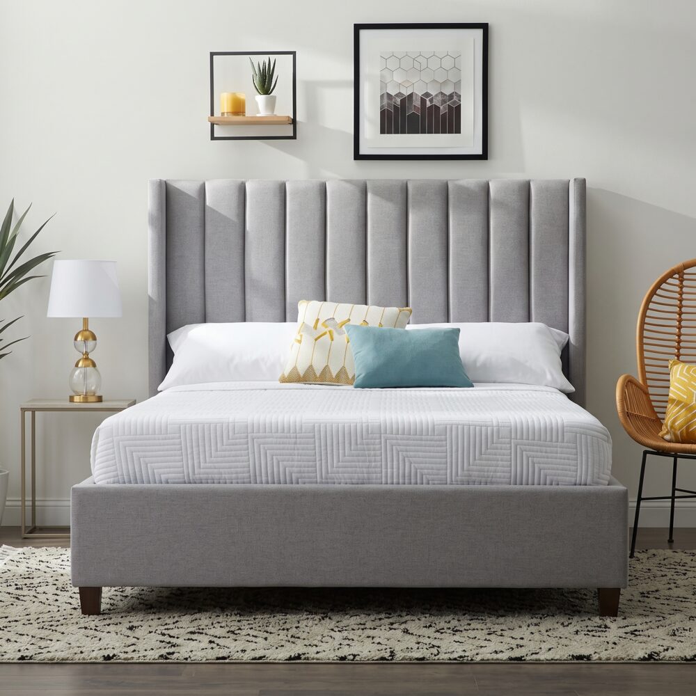 Modern grey upholstered platform bed with a tall wingback vertical channel-tufted headboard and solid wood legs in a contemporary bedroom.