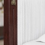 Classic walnut solid wood upholstered platform bed with an elegant arched fabric headboard and decorative brass accents in a sophisticated bedroom.
