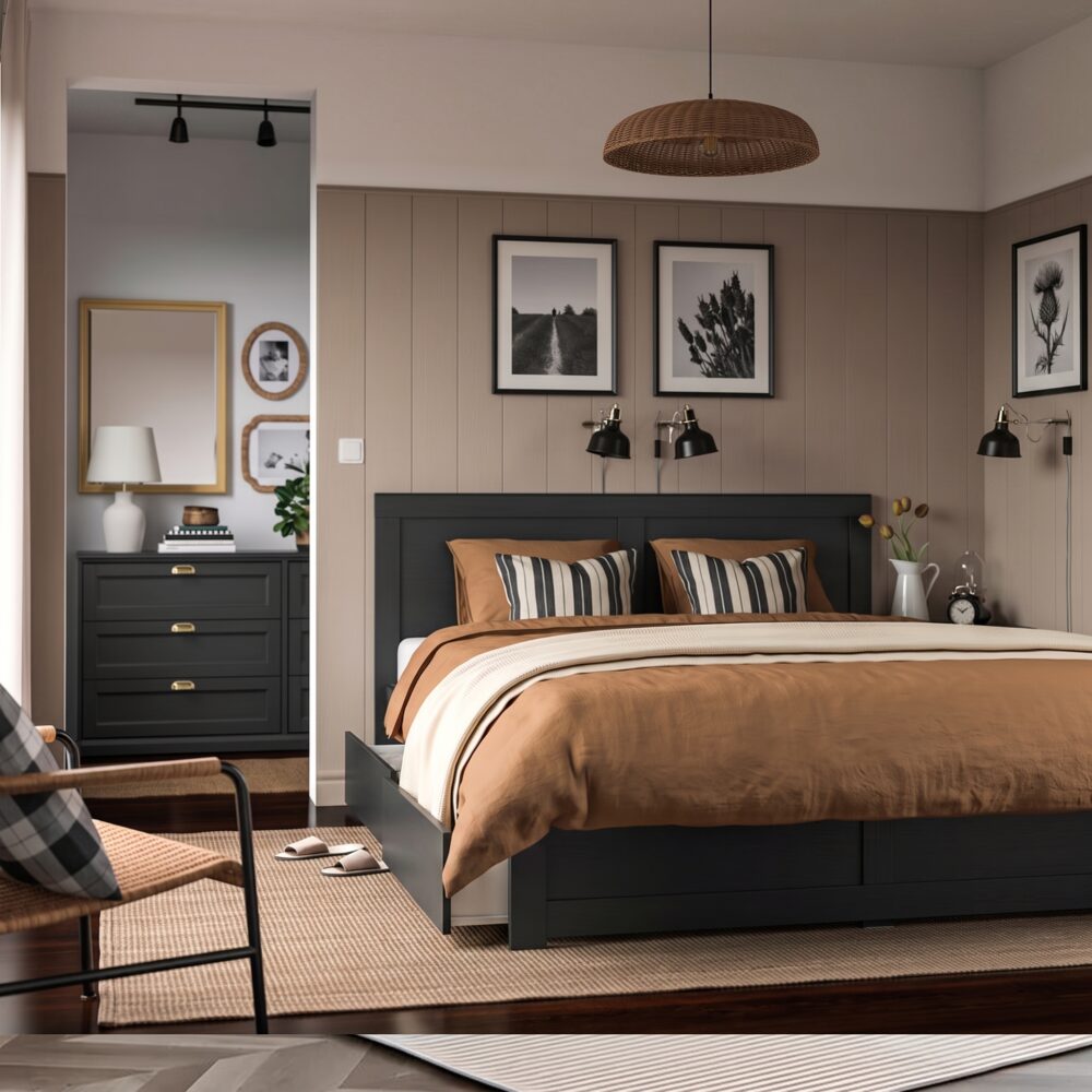 Modern black wooden platform bed with a panel headboard and built-in pull-out storage drawers in a contemporary bedroom.