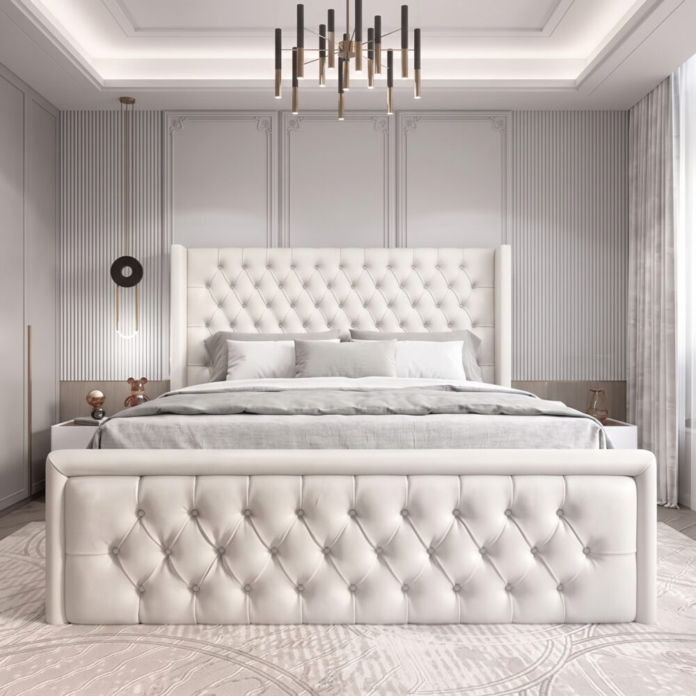 Luxury white upholstered platform bed with diamond-tufted wingback headboard and matching padded footboard in a modern bedroom.