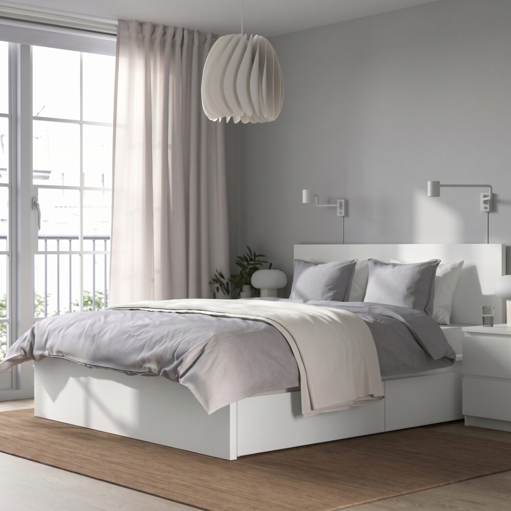 Modern white platform storage bed with built-in drawers, minimalist headboard, contemporary bedroom furniture in matte white finish.