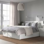 Modern white platform storage bed with built-in drawers, minimalist headboard, contemporary bedroom furniture in matte white finish.