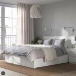 Modern white platform storage bed with built-in drawers, minimalist headboard, contemporary bedroom furniture in matte white finish.