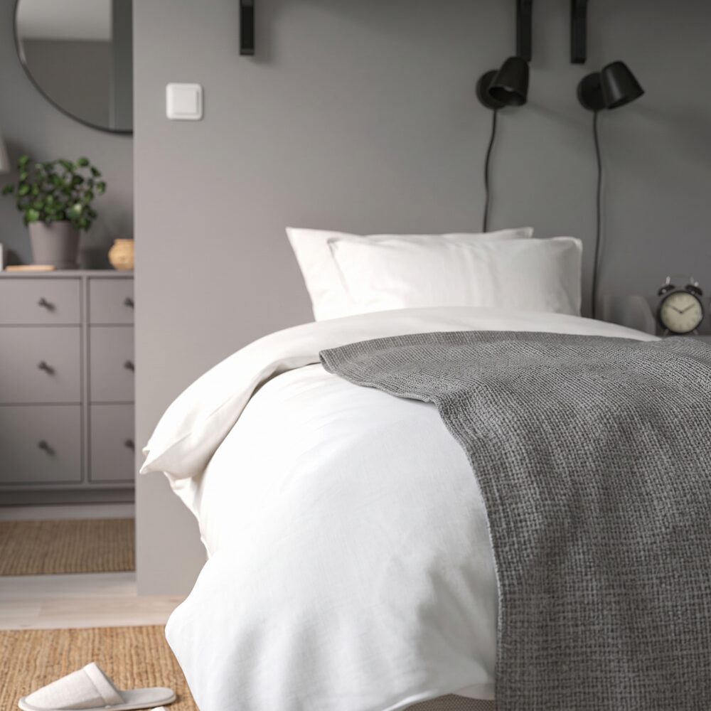 Modern beige upholstered platform bed with curved fabric headboard, contemporary minimalist bedroom furniture, neutral fabric finish, and elegant modern design.