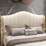 Luxury white upholstered platform bed with diamond tufted wingback headboard and matching upholstered footboard in a modern bedroom.
