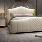 Luxury white upholstered platform bed with diamond tufted wingback headboard and matching upholstered footboard in a modern bedroom.
