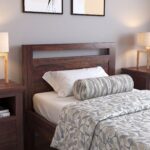Modern walnut wooden platform bed with minimalist open headboard and sturdy frame in a contemporary bedroom.