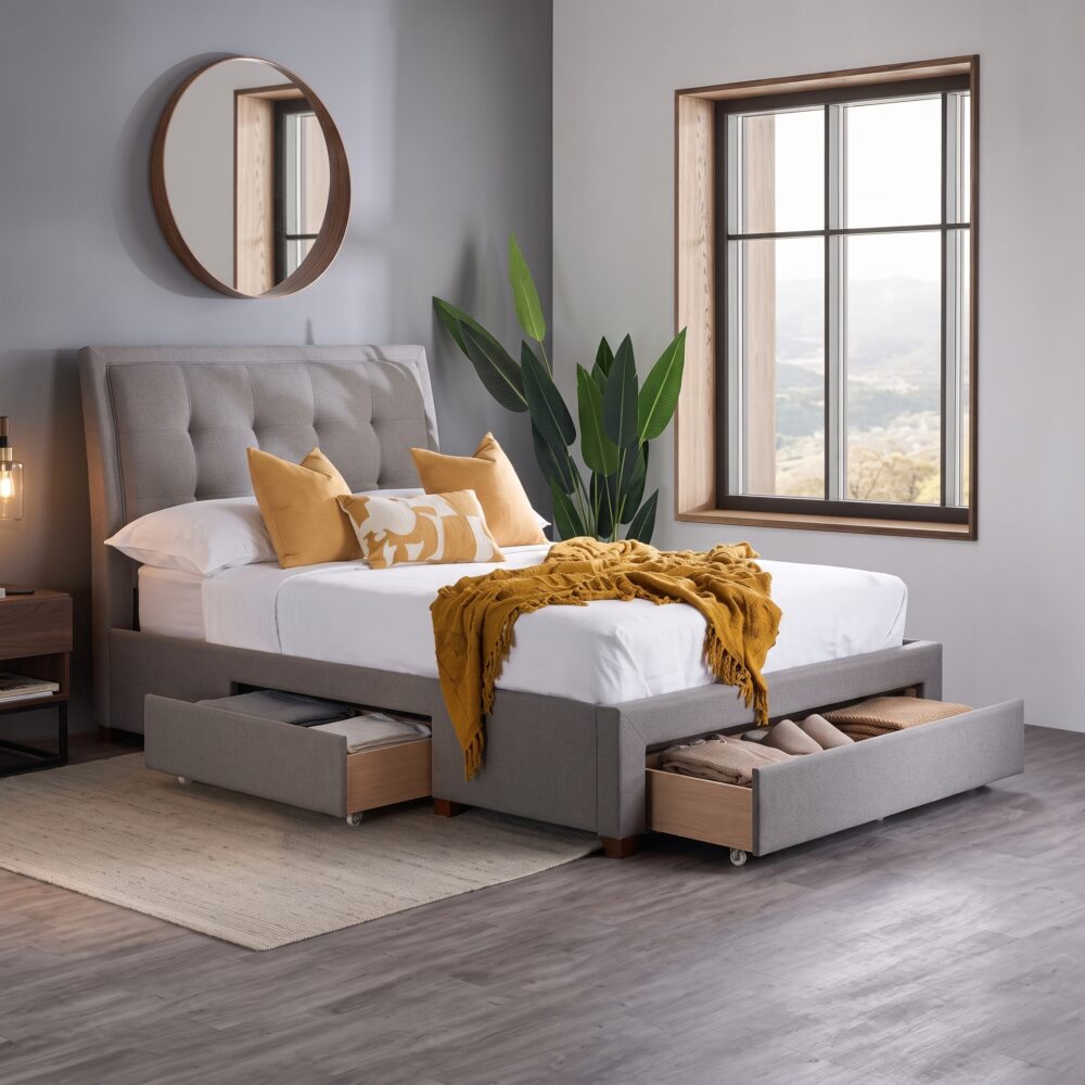 Modern gray upholstered platform bed with padded headboard and four pull-out storage drawers in a contemporary bedroom.