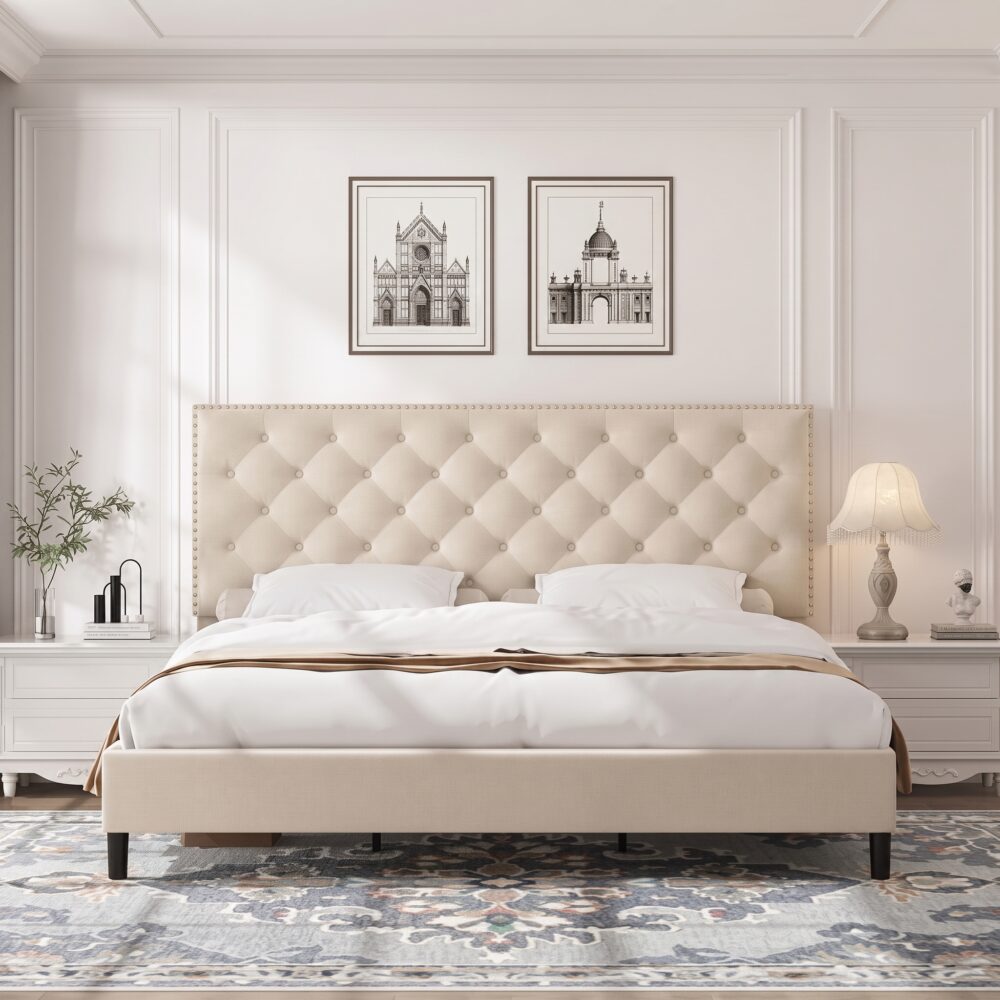 Modern beige upholstered platform bed with button tufted nailhead headboard, low-profile frame, sturdy wooden slats, and elegant contemporary bedroom design.