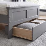 Modern grey wooden platform bed with a classic panel headboard and footboard, contemporary bedroom furniture featuring a durable engineered wood frame and minimalist design.