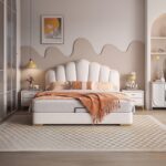 Luxury white upholstered platform bed with a scalloped padded headboard, gold trim accents, modern designer bedroom furniture, and contemporary upholstered frame.