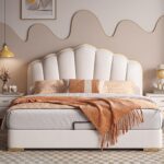 Luxury white upholstered platform bed with a scalloped padded headboard, gold trim accents, modern designer bedroom furniture, and contemporary upholstered frame.
