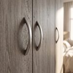 Modern 4-door wooden wardrobe with two bottom drawers in a light oak finish for bedroom storage.