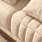 Modern Cream Fluted 3-Seater Sofa with vertical channel tufting, premium cream fabric upholstery, curved armrests, and solid wood base in a contemporary living room.