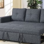 Modern dark grey fabric sofa cum bed with pull-out sleeper mechanism displayed in a contemporary living room, converted into a spacious bed for guests.
