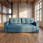 Modern teal fabric sofa cum bed with tufted back cushions, integrated armrest cup holders, wooden base, and convertible sleeper design in a contemporary loft-style living room.