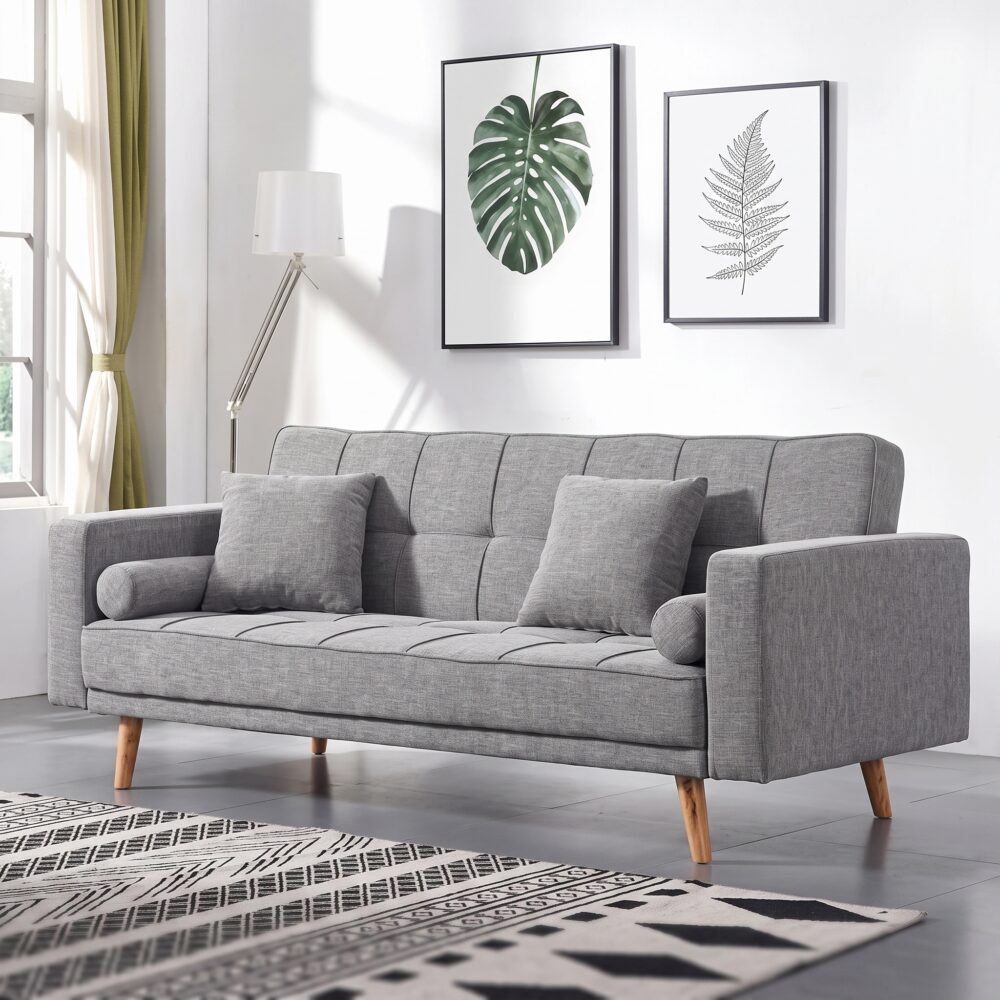 Modern grey fabric convertible sofa bed with tufted backrest, wooden legs, square cushions, bolster pillows, and Scandinavian design for living room furniture.
