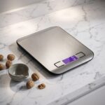Homslux Kitchen Scale with stainless steel platform and digital display on marble kitchen countertop