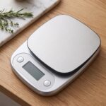 Homslux Kitchen Scale digital food scale with stainless steel platform on a wooden kitchen countertop
