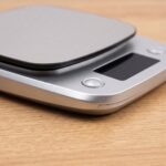 Homslux Kitchen Scale digital food scale with stainless steel platform on a wooden kitchen countertop
