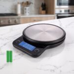 Homslux digital kitchen scale with brushed stainless steel circular platform on a white marble countertop