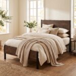 Rustic wood and matte black metal single bed frame styled with neutral beige bedding and waffle throw blanket.