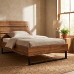 Modern wooden single bed frame with horizontal slatted headboard and black metal sled legs styled in a sunlit bedroom over a woven jute rug.