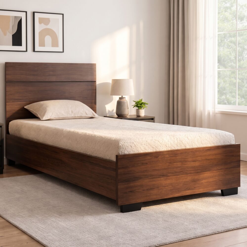 Modern walnut wood single bed frame with matching solid headboard and footboard styled with light beige bedding in a sunlit bedroom.