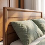 Wooden single bed frame with hydraulic gas-lift mechanism open showing folded blankets and towels stored inside under-bed compartment.